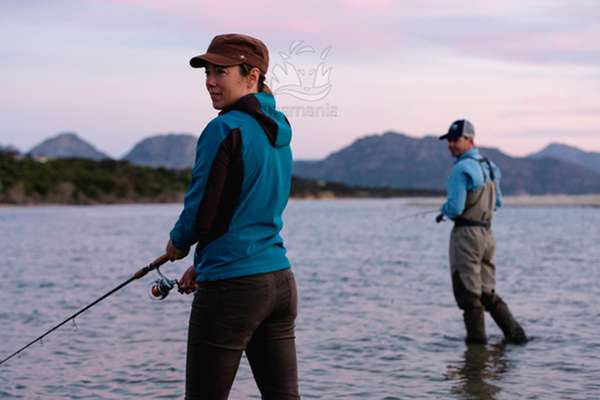 Cover photo for the DRAFT Strategy to Increase Participation in Tasmania’s Inland Recreational Fishery 2021–28 taken during a Tourism Tasmania campaign photo shoot of a man and a woman fishing still, shallow water