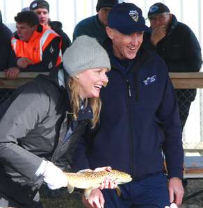 ohn Diggle, Director of Inland Fisheries and Sarah Courtney, Minister for Primary Industries and Water, hold a brown trout at Trout Weekend 2018
